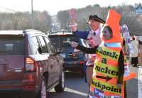 In Hagerstown, MD March 4, 2022, (3/4/2022)  Volunteer dressed in costume of a Giant Orange Cone, that says  "Thank a Trucker Checkpoint" and George Washington welcome the Truckers to stand with them to Protect Religious Freedom.